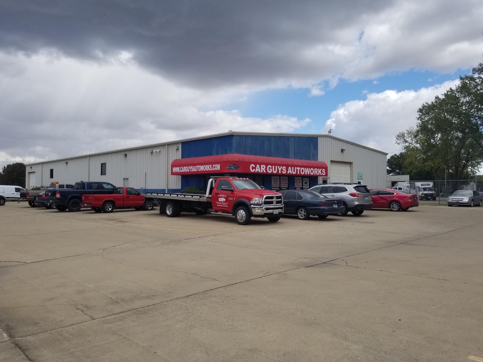 The Car Guys Autoworks shop on Stanton Street with its red awning and tow truck