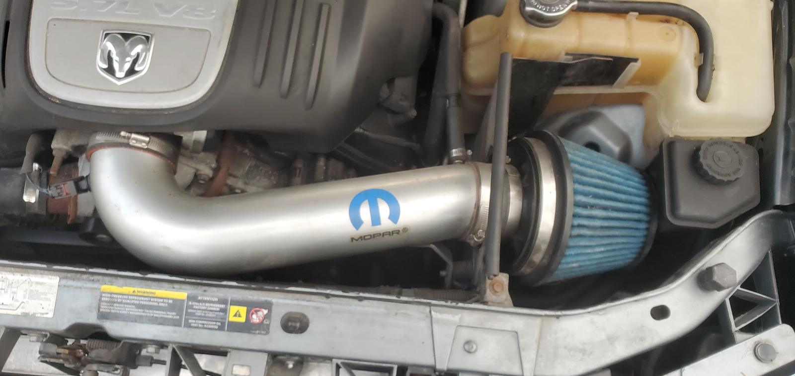 Engine bay of a Dodge with a Mopar cold air intake